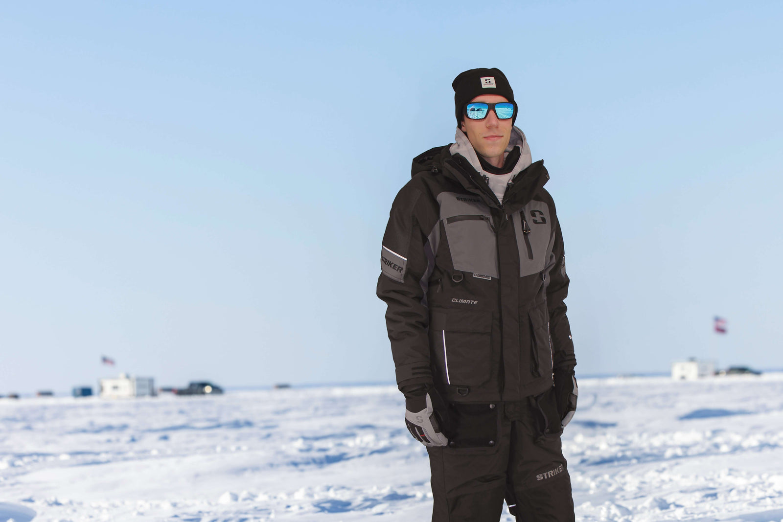 Person wearing a black and gray winter suit on a snowy landscape