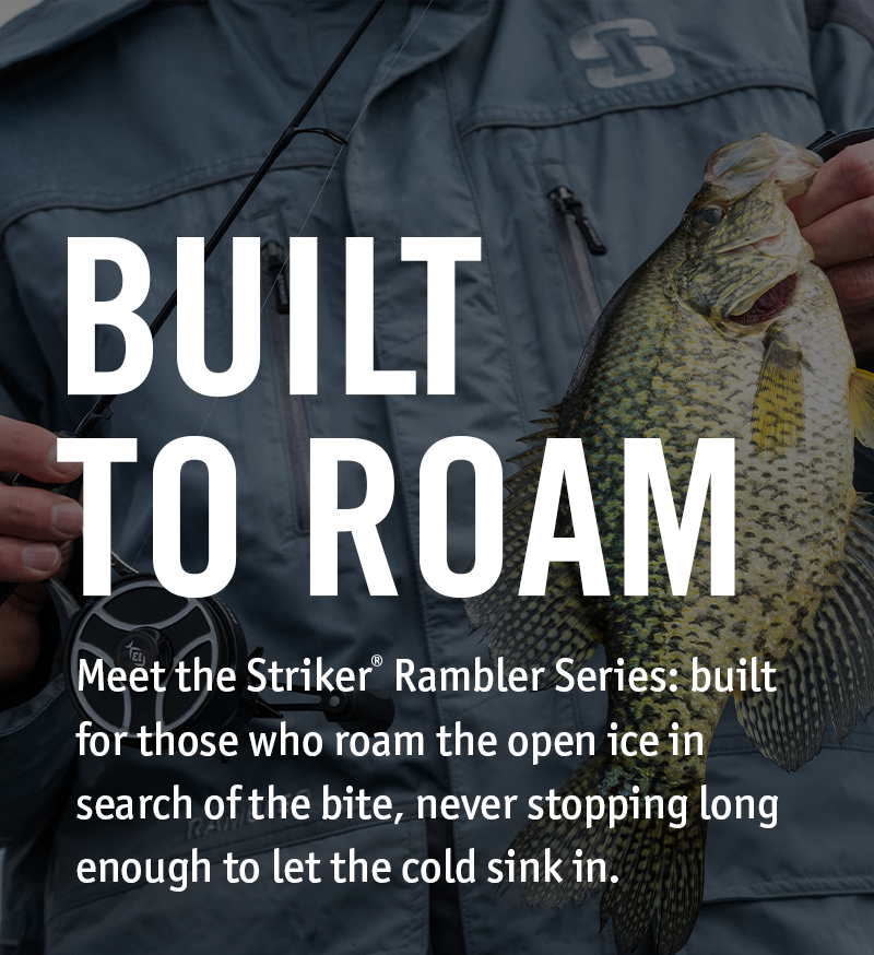 A person wearing a dark gray Striker jacket holds a crappie fish while wearing a fly fishing rod. Large white text reads 'BUILT TO ROAM' with smaller descriptive text below.